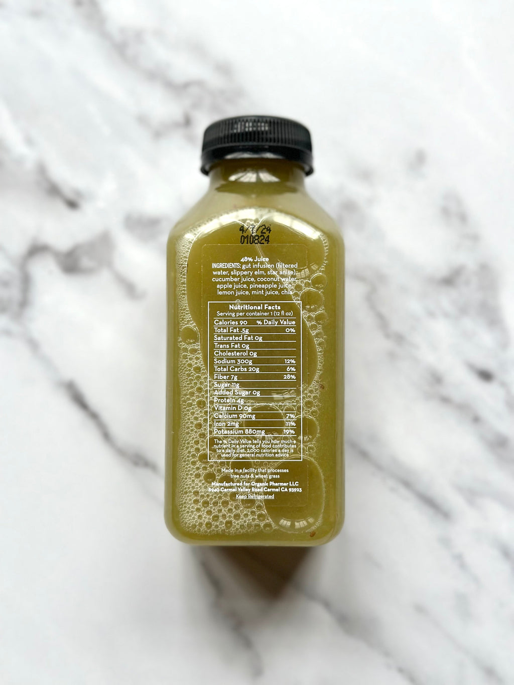 Amber-gold drink bottle with black cap; back label with ingredient and directions text