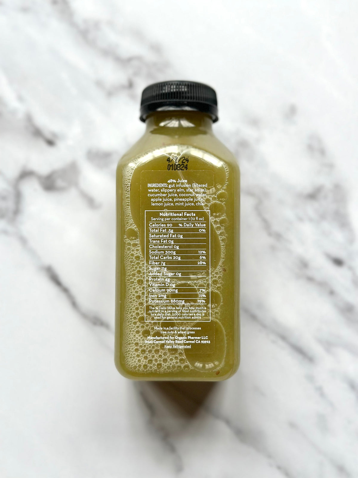 Amber-gold drink bottle with black cap; back label with ingredient and directions text