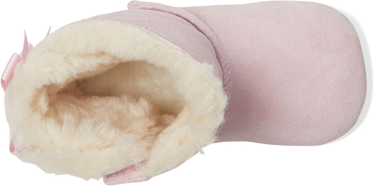 Pink baby suede booties shown from the side with soft fur lining inside