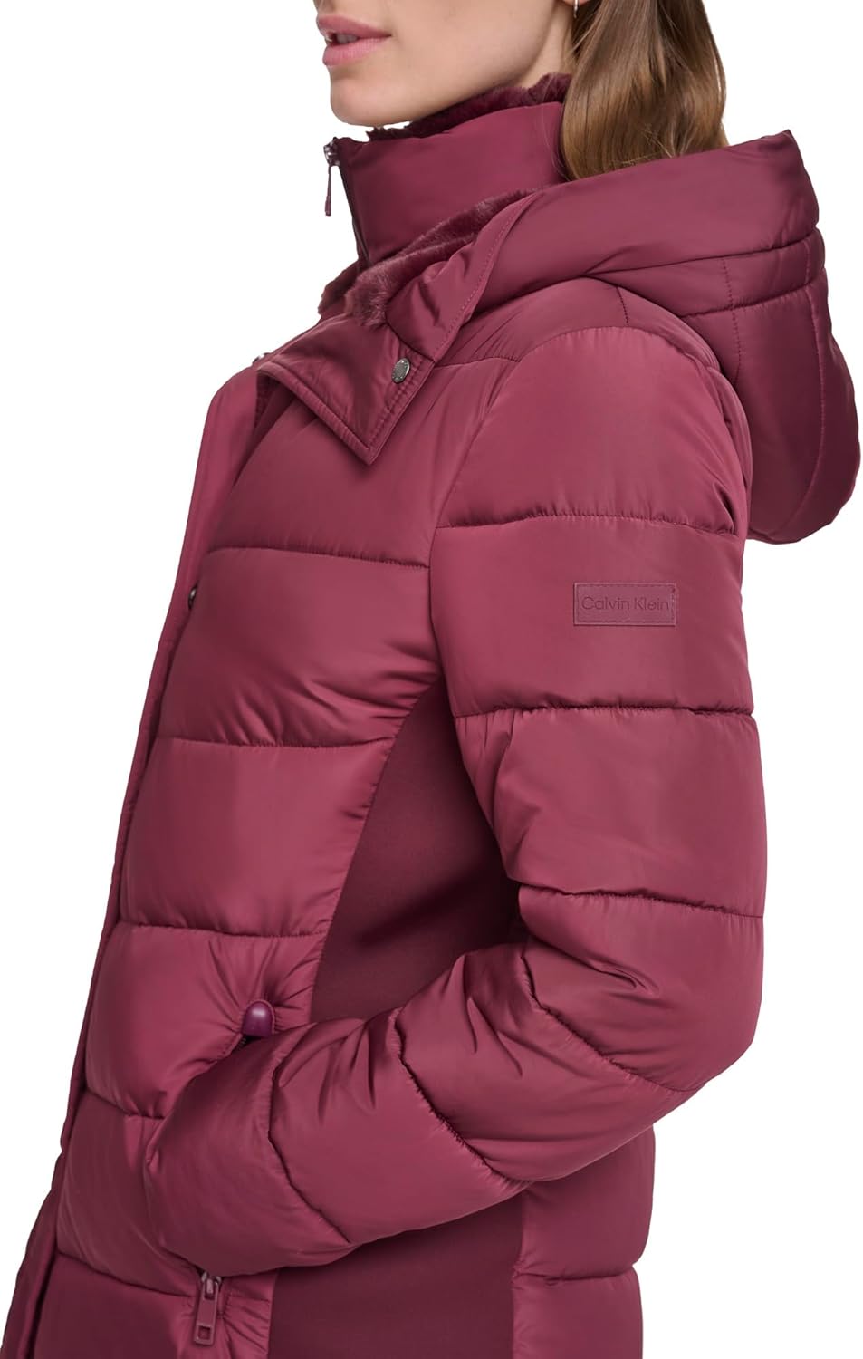 Women’s maroon long puffer jacket with faux-fur hood trim and zip pocket detail
