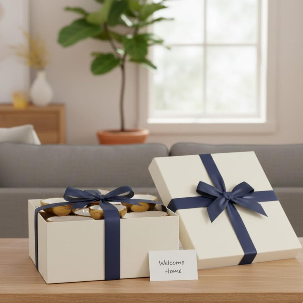 Cluster of 9 round enamel serving bowls in an open gift box with navy ribbon