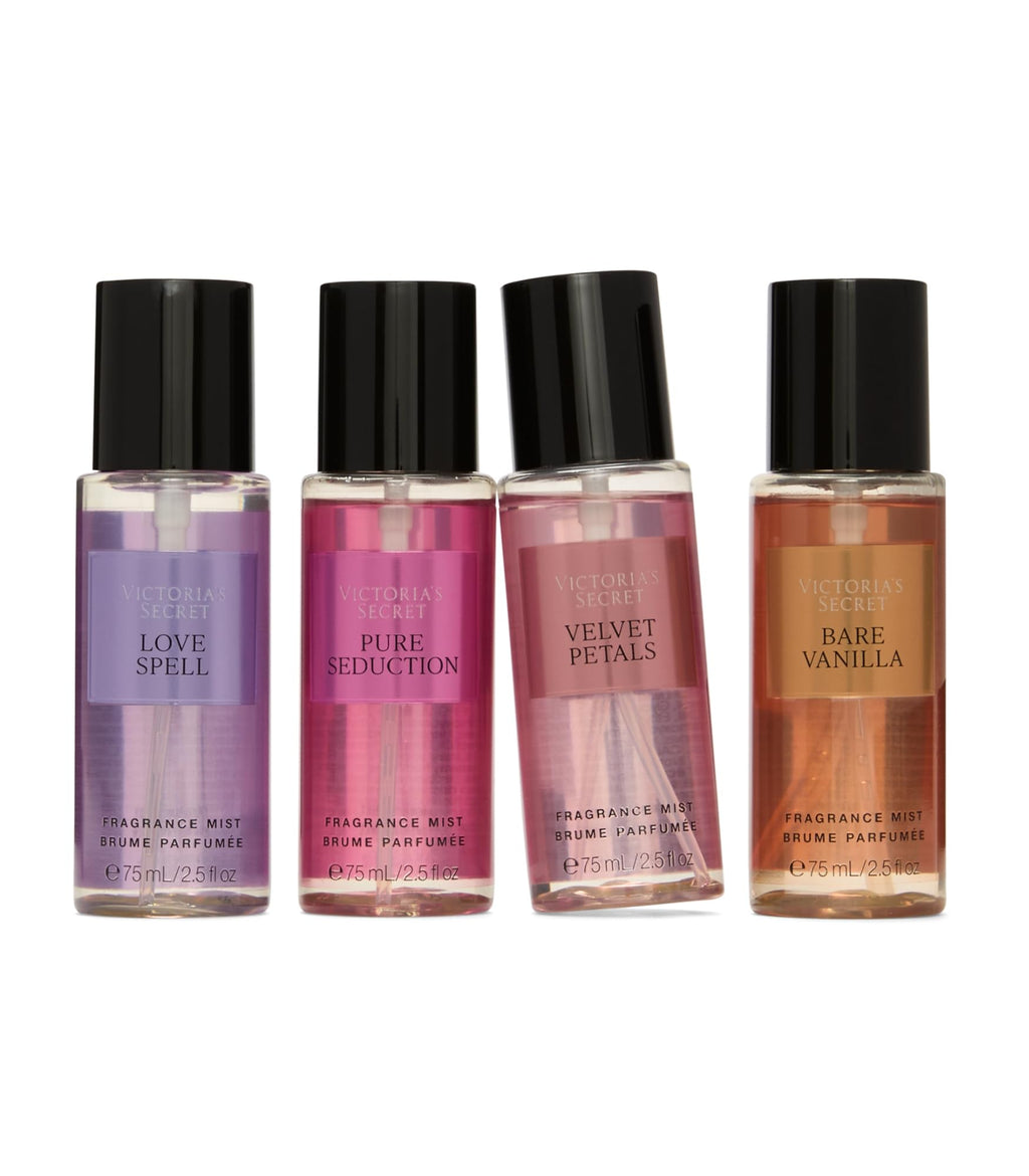 Four mini fragrance mist bottles with black caps in purple, pink, clear, and amber