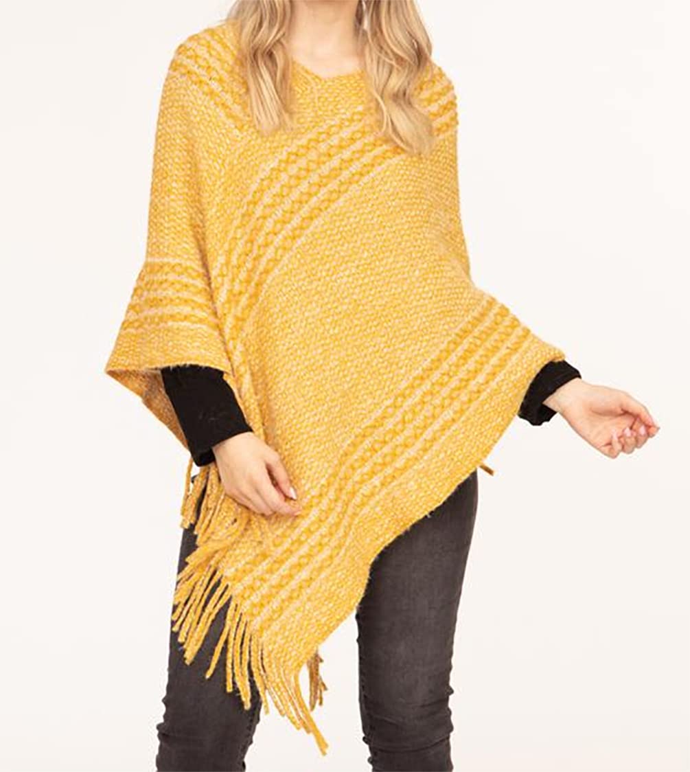 Women's yellow striped V-neck knitted poncho with fringe tassels, worn with dark pants