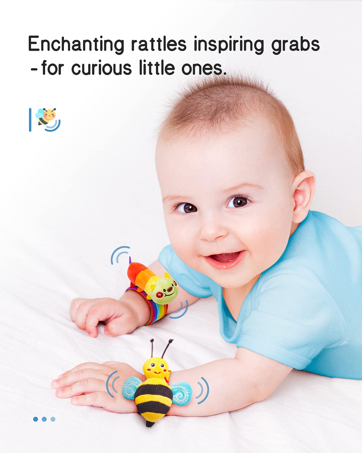 Baby reaching for a blue-and-yellow bee wrist rattle plush toy