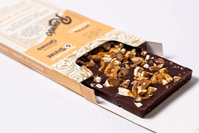 Coconut caramel and crushed cashew dark chocolate bark pieces in open box