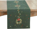 Green Christmas table runner with embroidered wreath and red bow centerpiece