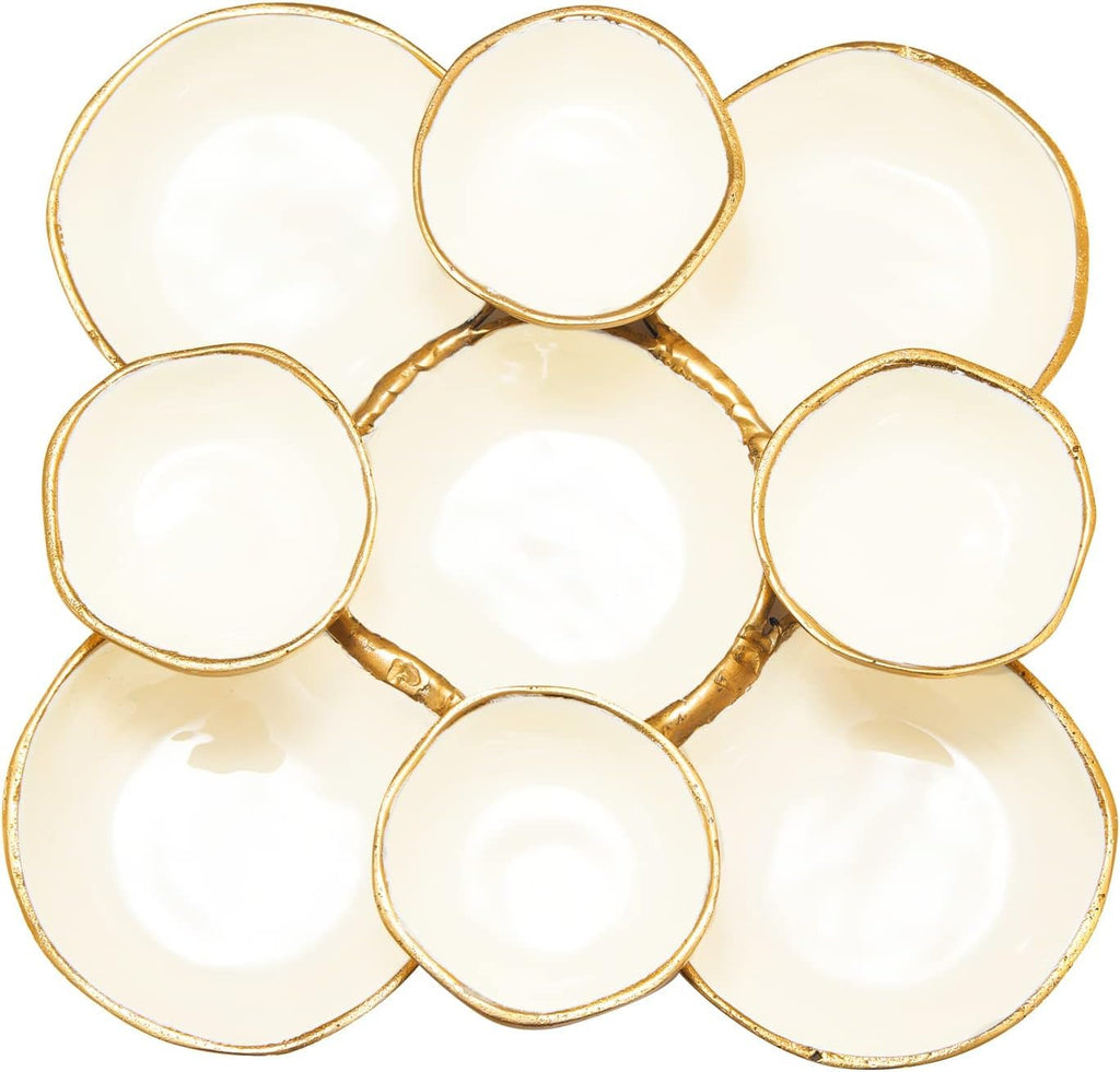 Close-up of round enamel serving bowls with gold edges and white centers