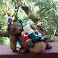 Garden bear yard statue with green beer bottle and four gnome figurines on back