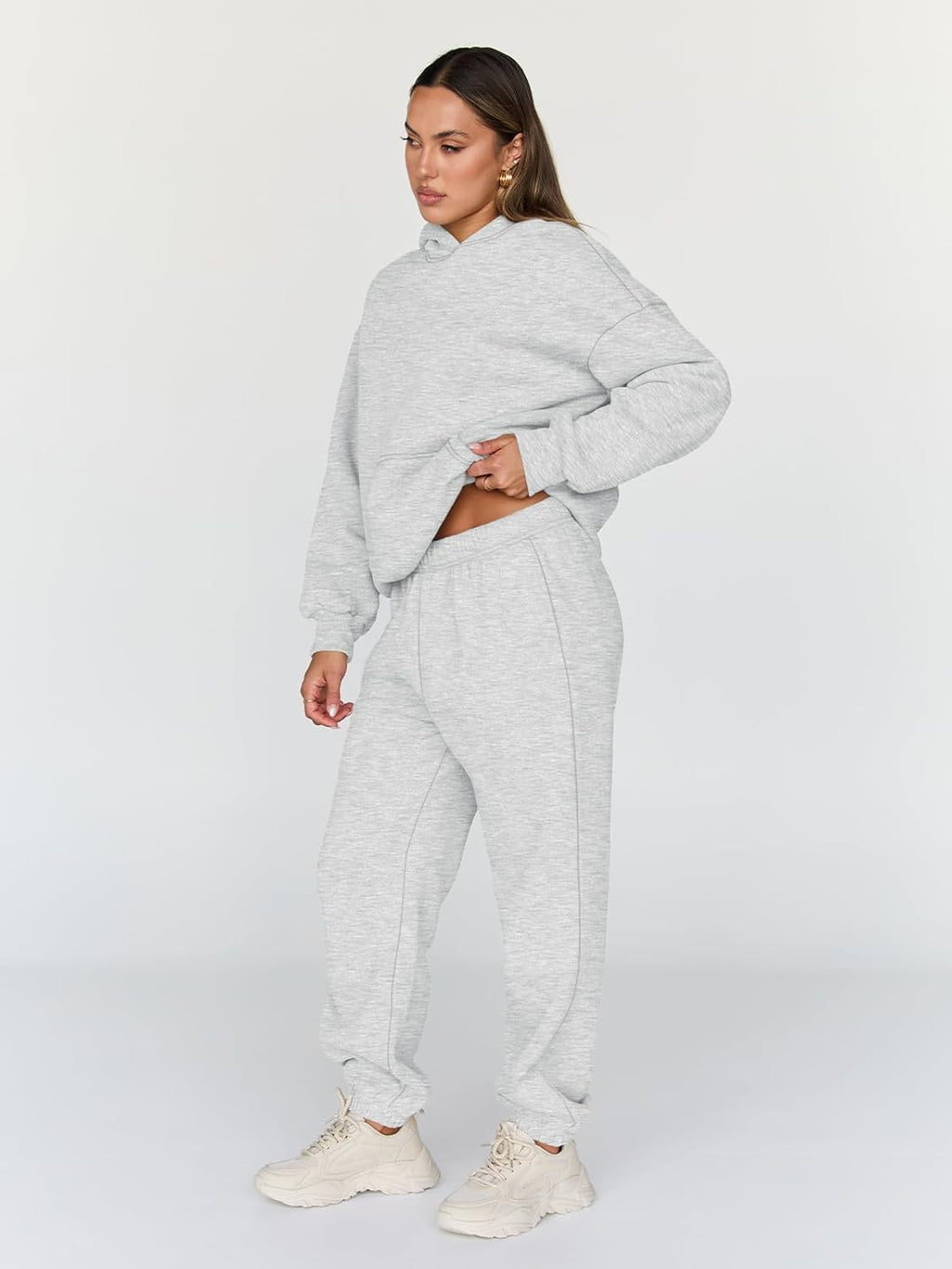 Light gray hoodie and matching jogger sweatpants set, side view with hood up