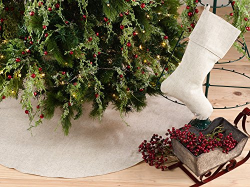 Natural round Christmas tree skirt with wide hem, shown under a tree and gifts