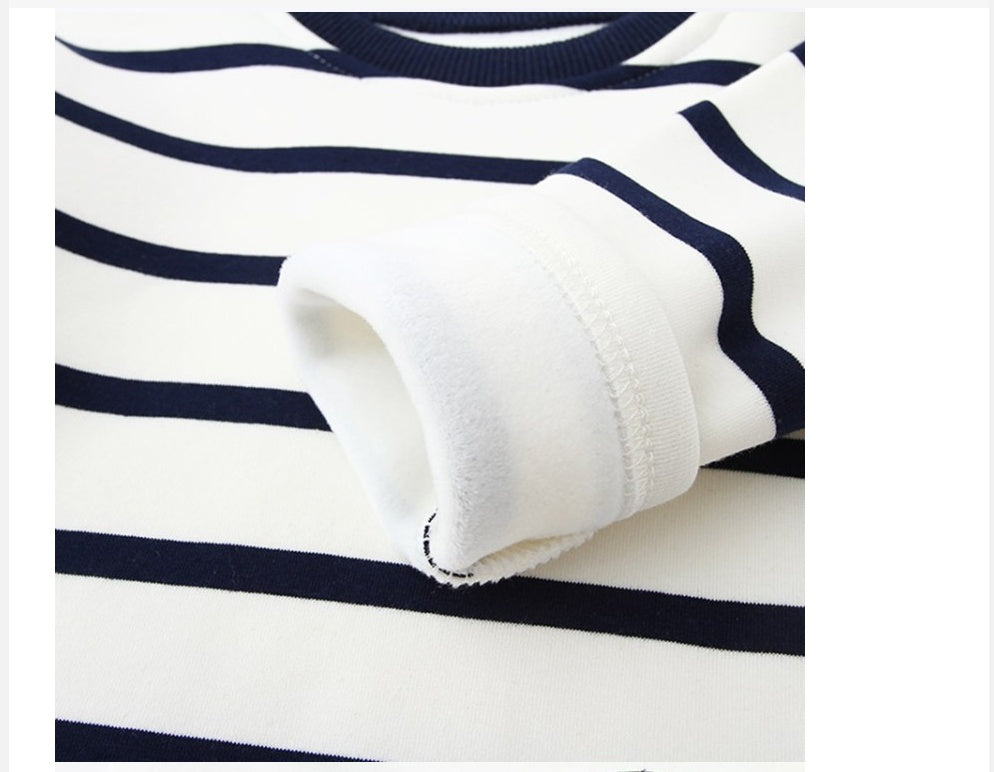 Children's navy-and-white striped sweater sleeve close-up with soft cuff