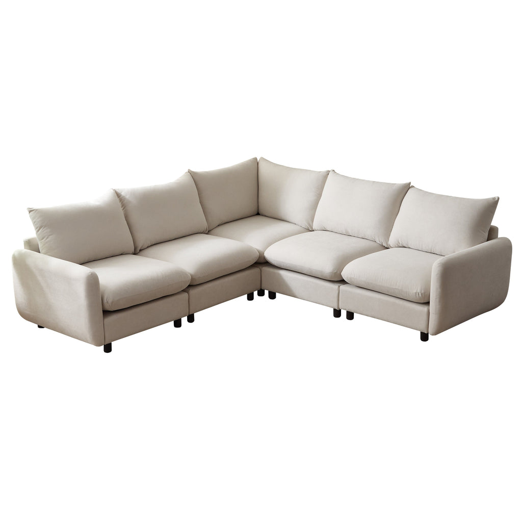 White modular L-shaped sectional sofa with tufted back cushions and angled chaise