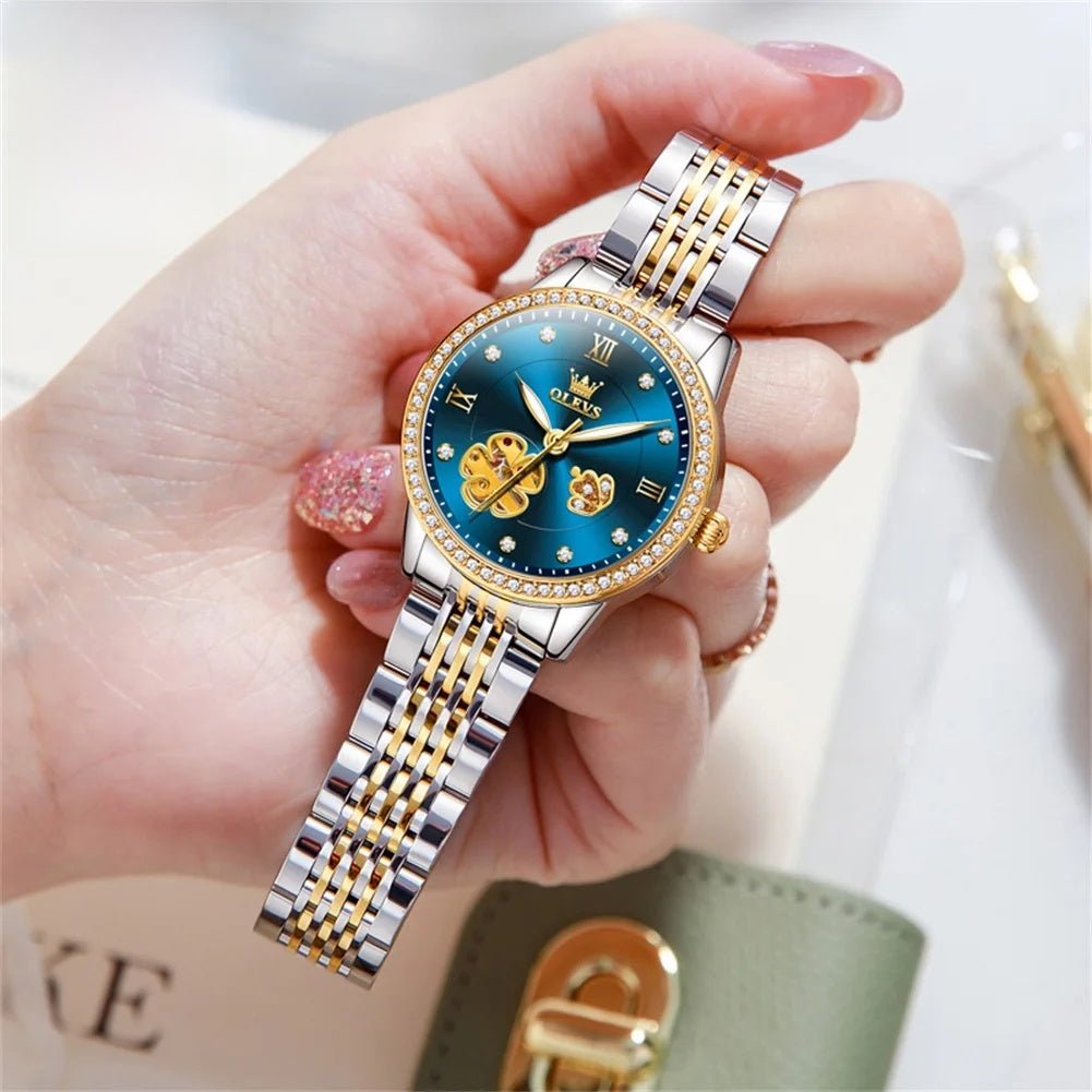 Two-tone automatic bracelet watch with blue floral dial, gold hands, jeweled bezel