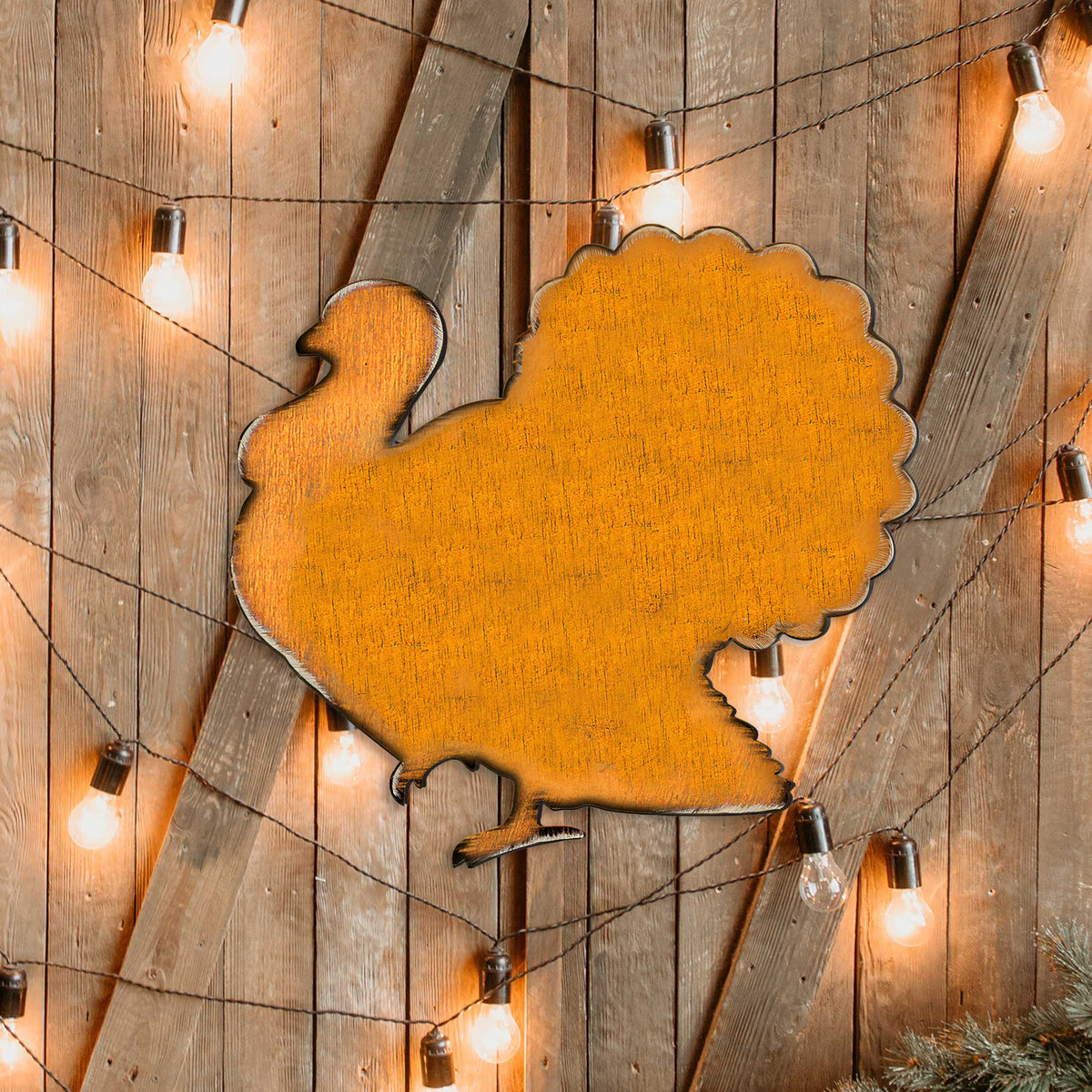 Orange wooden turkey door hanger with scalloped outline and attached loop