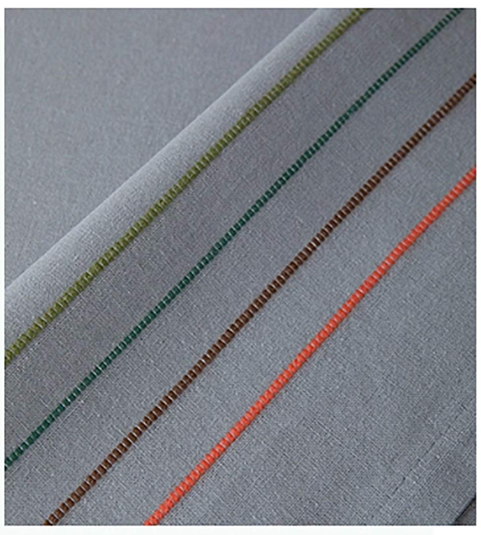 Close-up of light grey cotton tablecloth with multicolor striped trim along the edge.