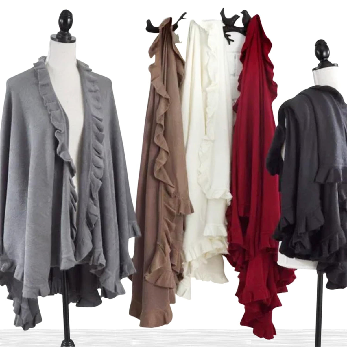 Set of ruffle-trim knit poncho capes in gray, tan, ivory, and red on mannequins
