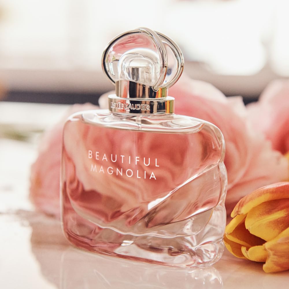 Eau de parfum bottle close-up with silver spray top and pink-tinted glass