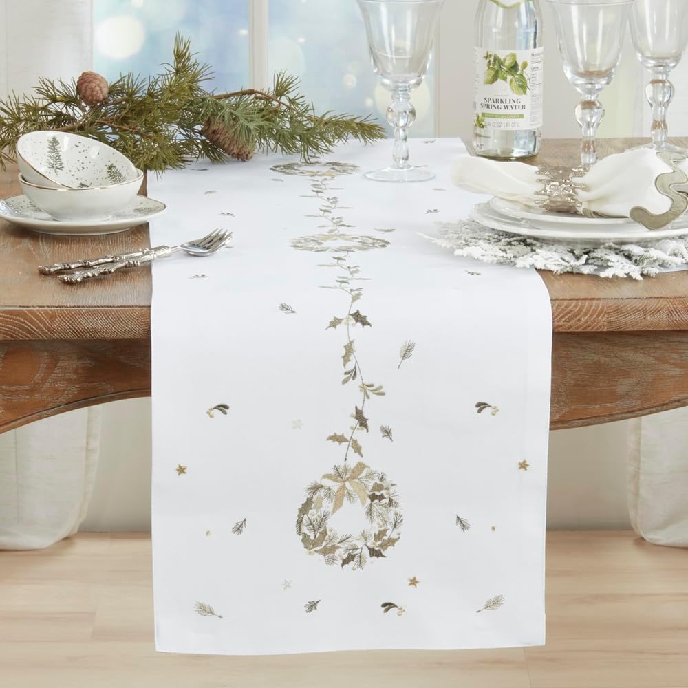 White Christmas table runner with embroidered wreath and scattered gold star motifs