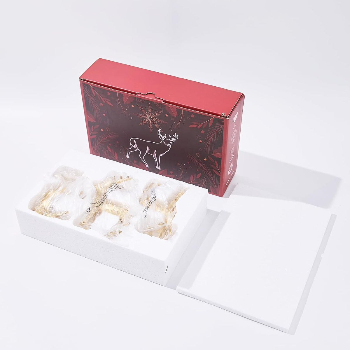 Three gold resin reindeer figurines in a red gift box, set of 3