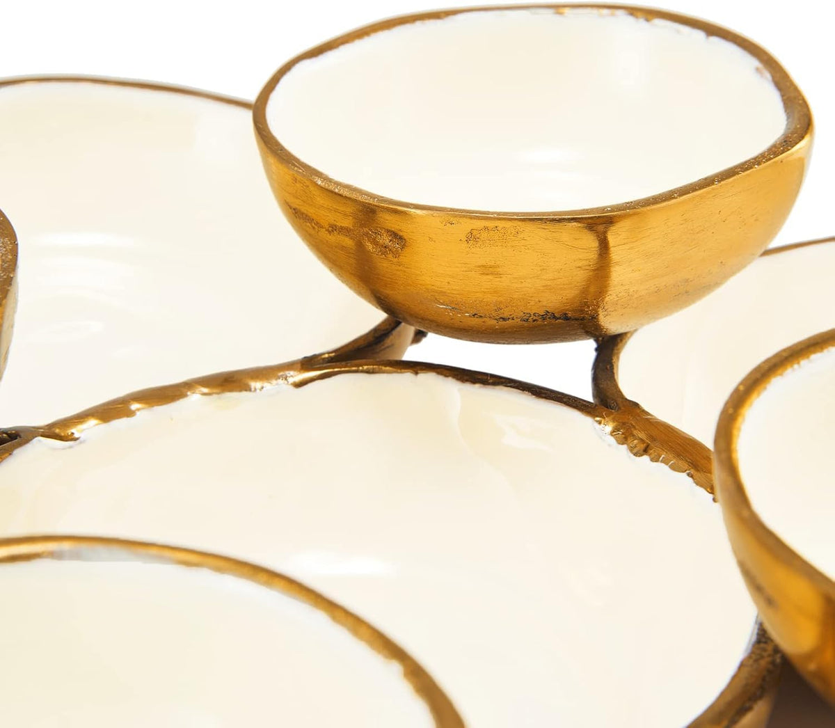 Close-up view of a round gold-rimmed bowl with white enamel interior