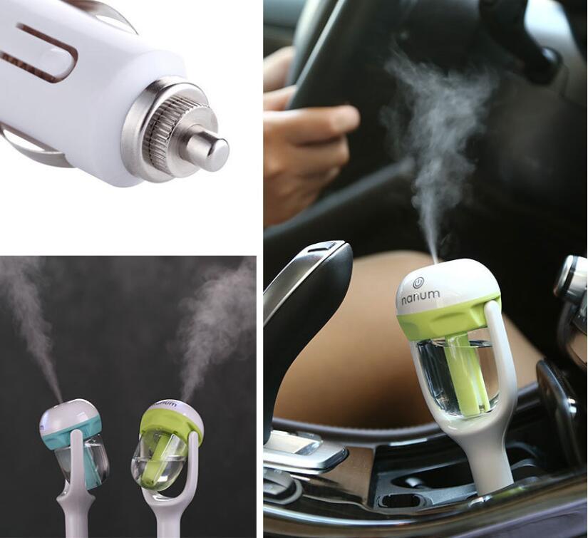 White car aroma diffuser with metal plug and mist coming from the clear tank