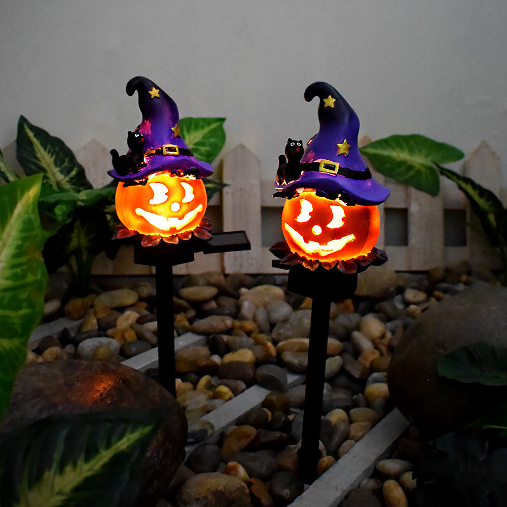 Solar Halloween pumpkin lantern stake light with purple witch hat, glowing jack-o’-lantern faces