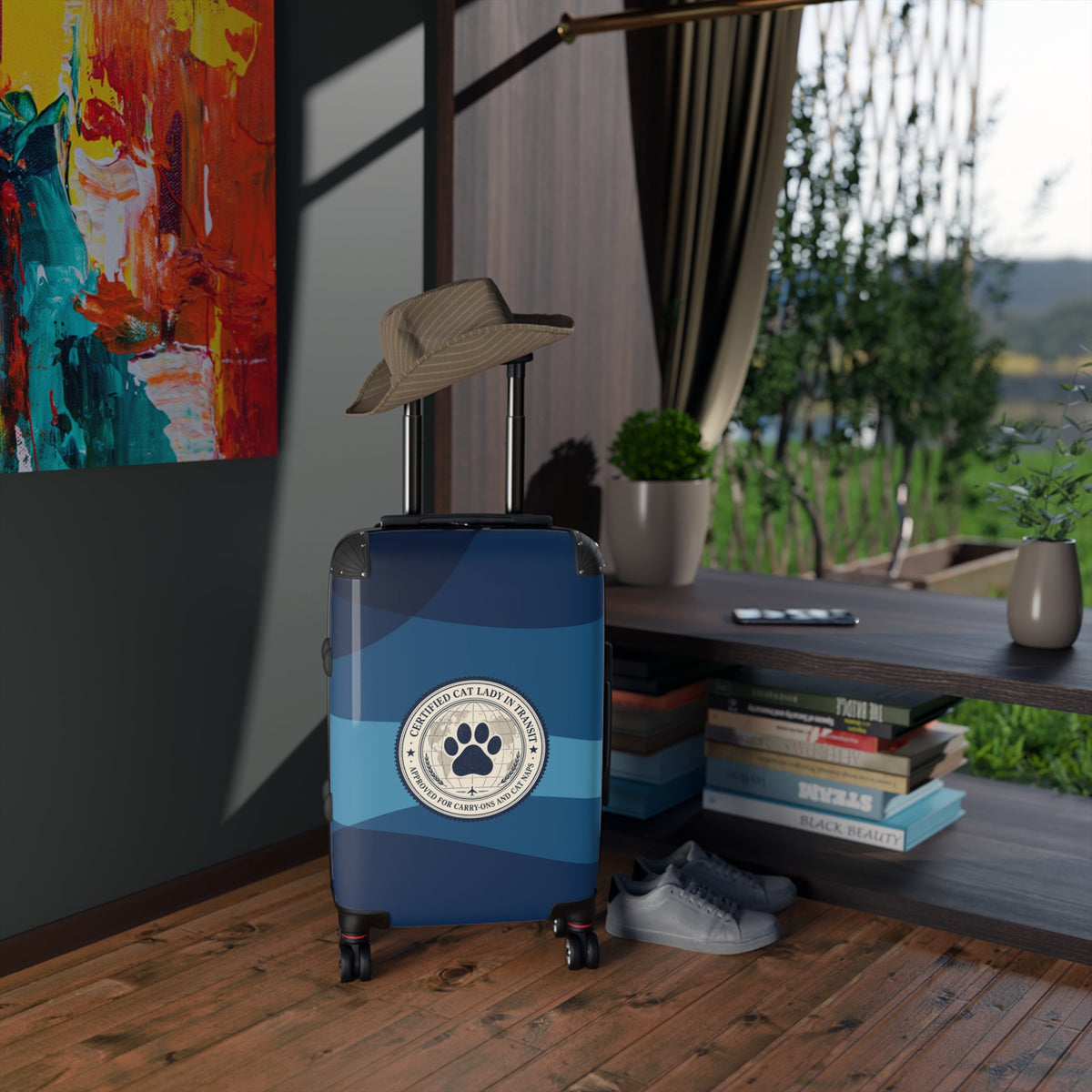 Hard-shell suitcase with paw emblem on blue-and-dark striped shell, on rolling wheels