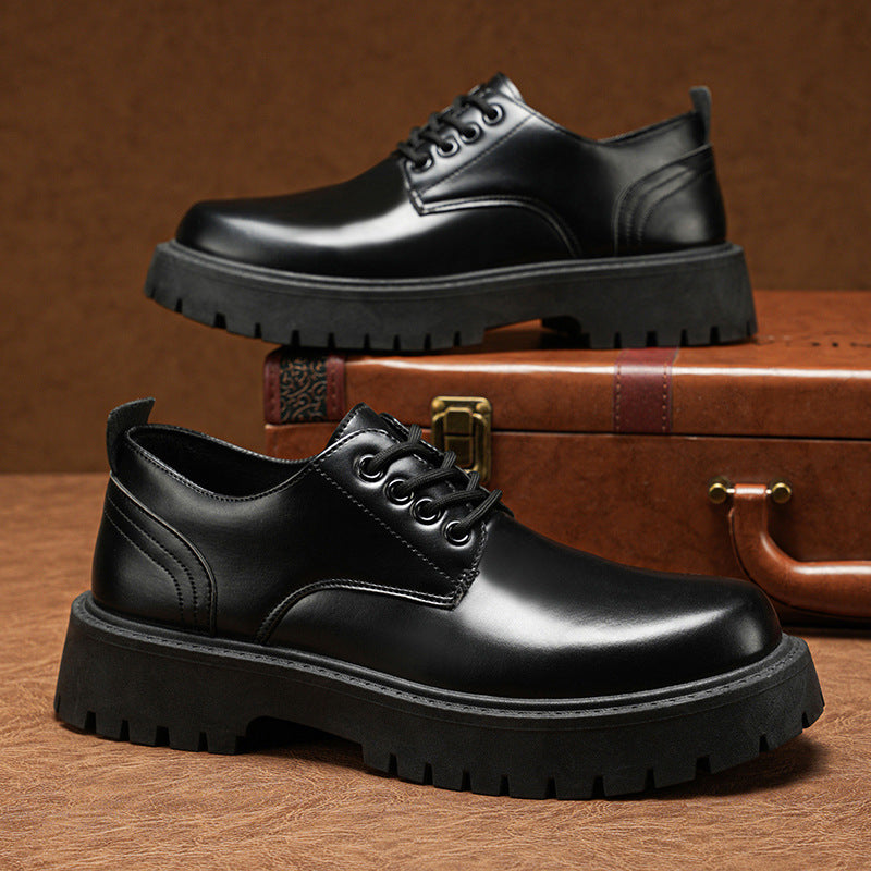 Black lace-up derby dress shoes with thick tread sole and stitched toe panel.
