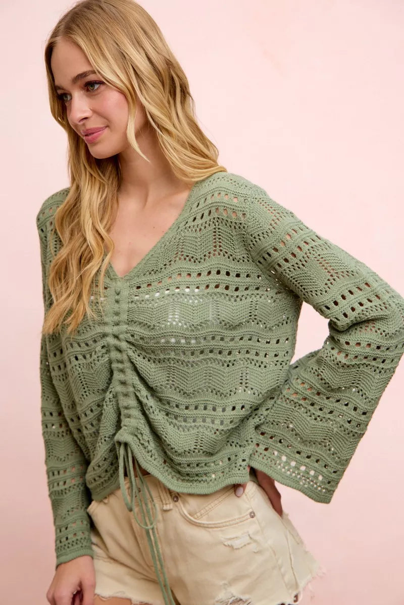Sage green pointelle knit V-neck top with ruched gathered front and long sleeves