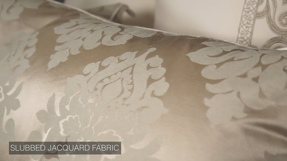 Slubbed jacquard fabric swirls in ivory with subtle raised damask pattern