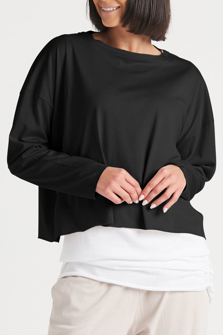 Black boxy long-sleeve T-shirt over white layer, crew neck