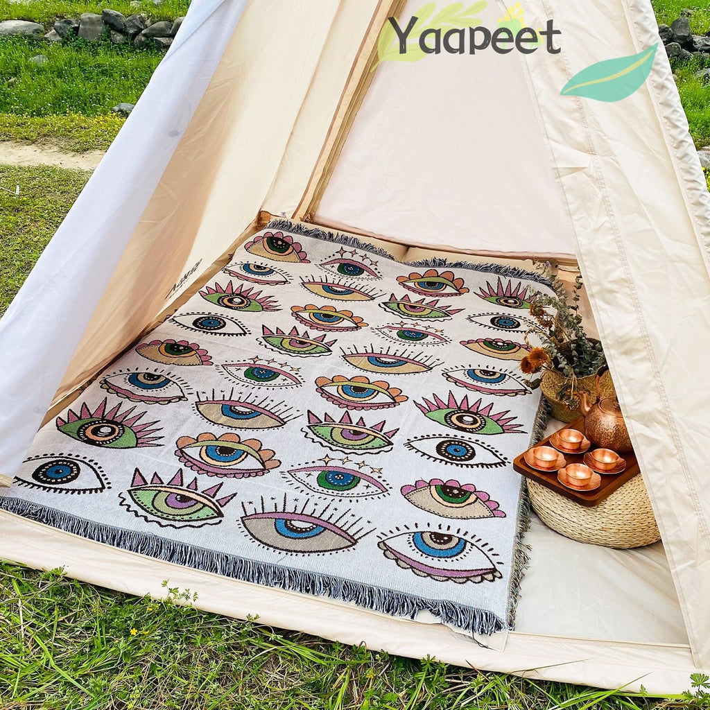 Evil eye beach blanket with multicolor eye pattern and fringe border