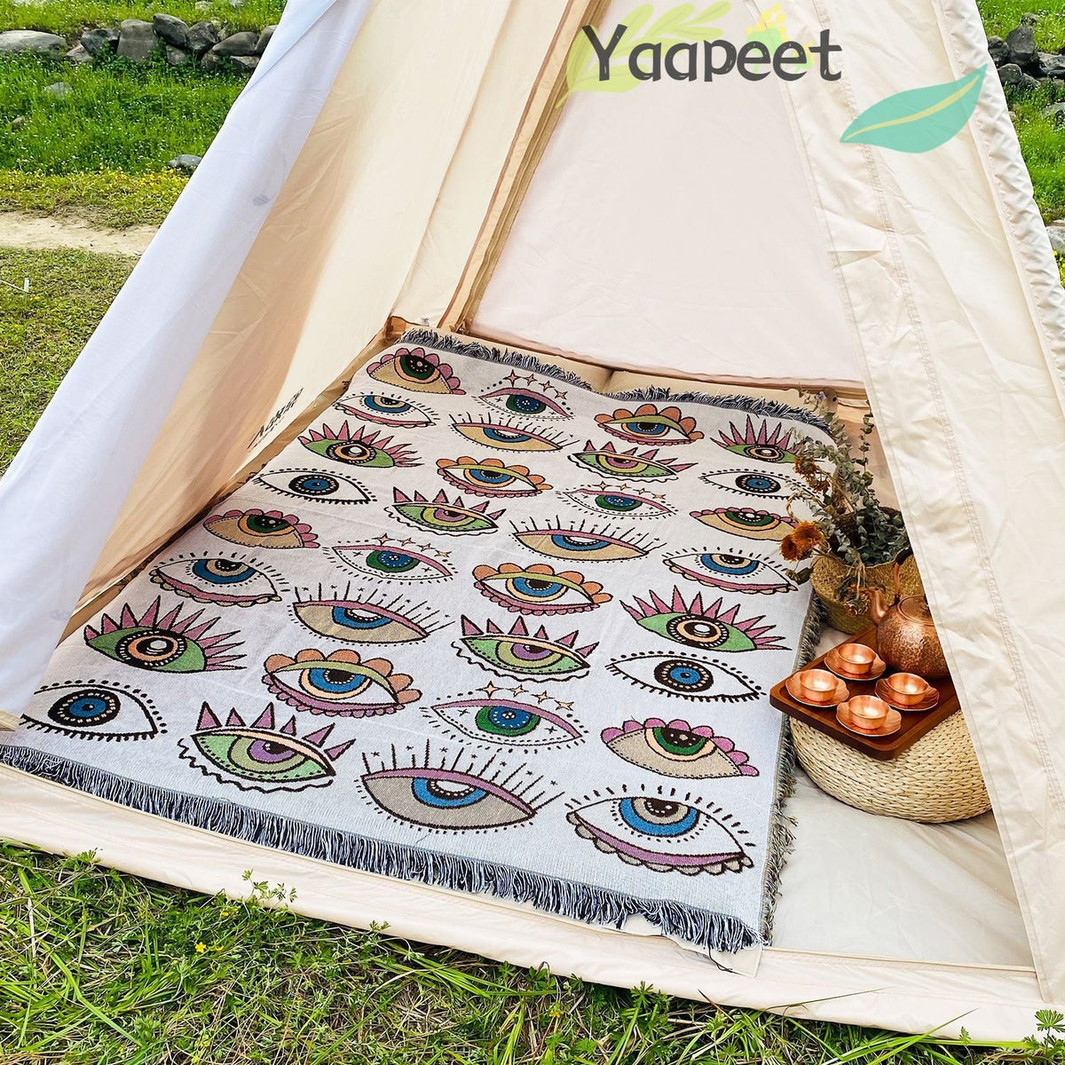 Evil eye beach blanket with multicolor eye pattern and fringe border