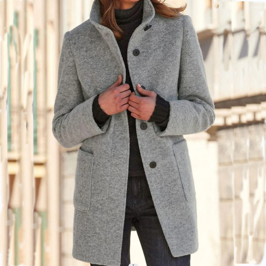 Light gray wool coat with stand collar, button front, and side pockets