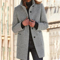 Light gray wool coat with stand collar, button front, and side pockets