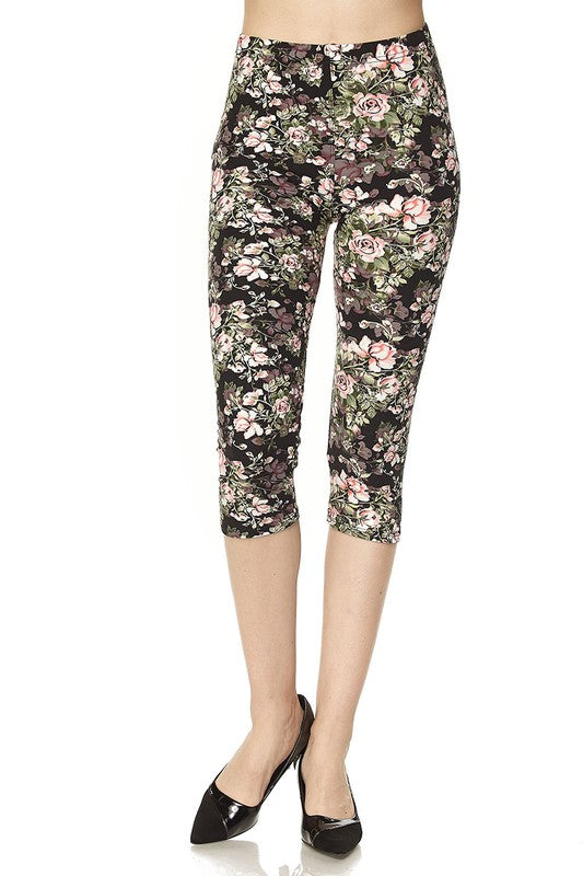 Floral print capri pants with pink and green blooms on dark fabric