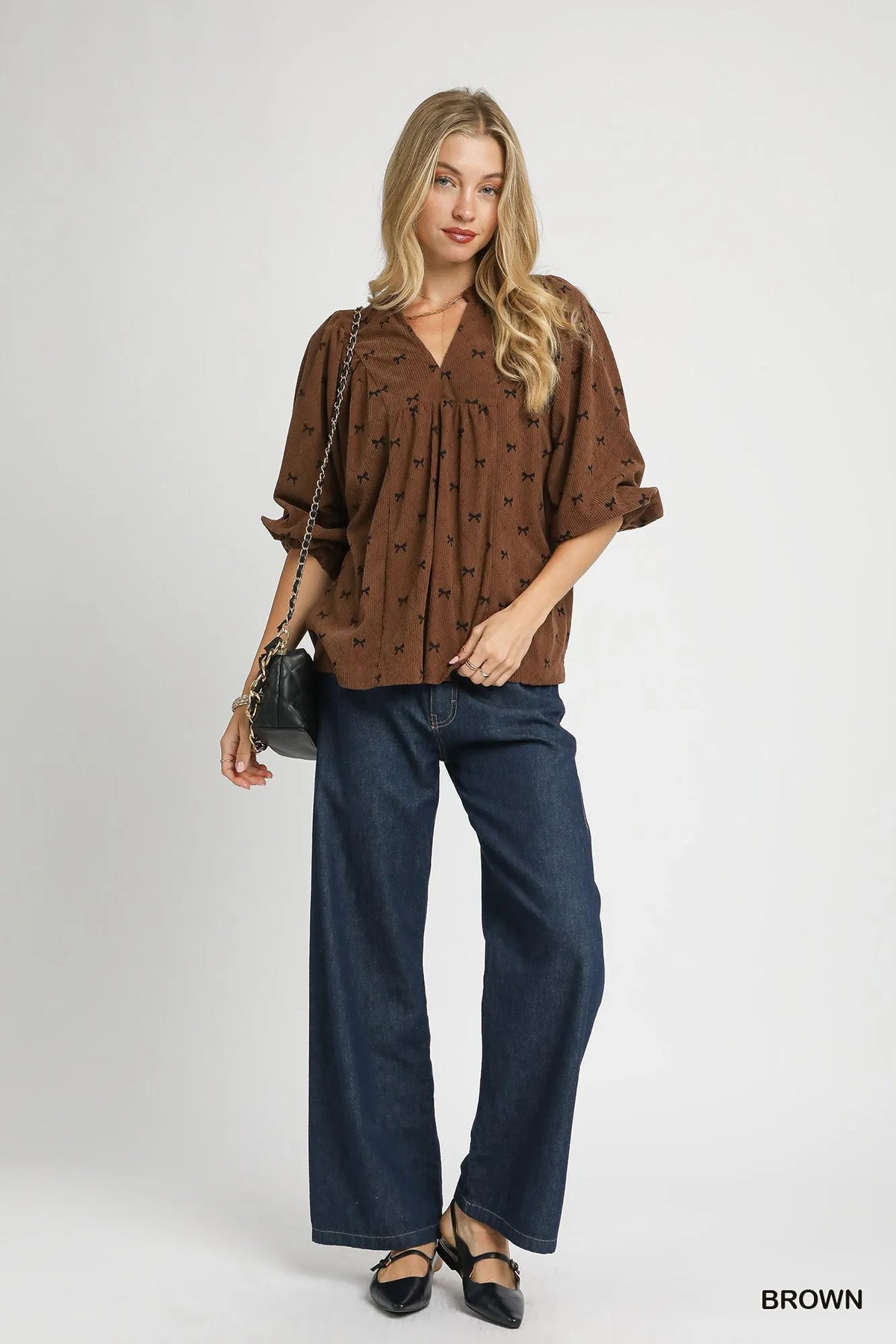 Brown corduroy bow-print blouse with V-neck and balloon sleeves, gathered at waist