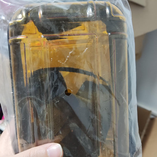 Cosmetic bag in yellow with dark geometric print, sealed in plastic.