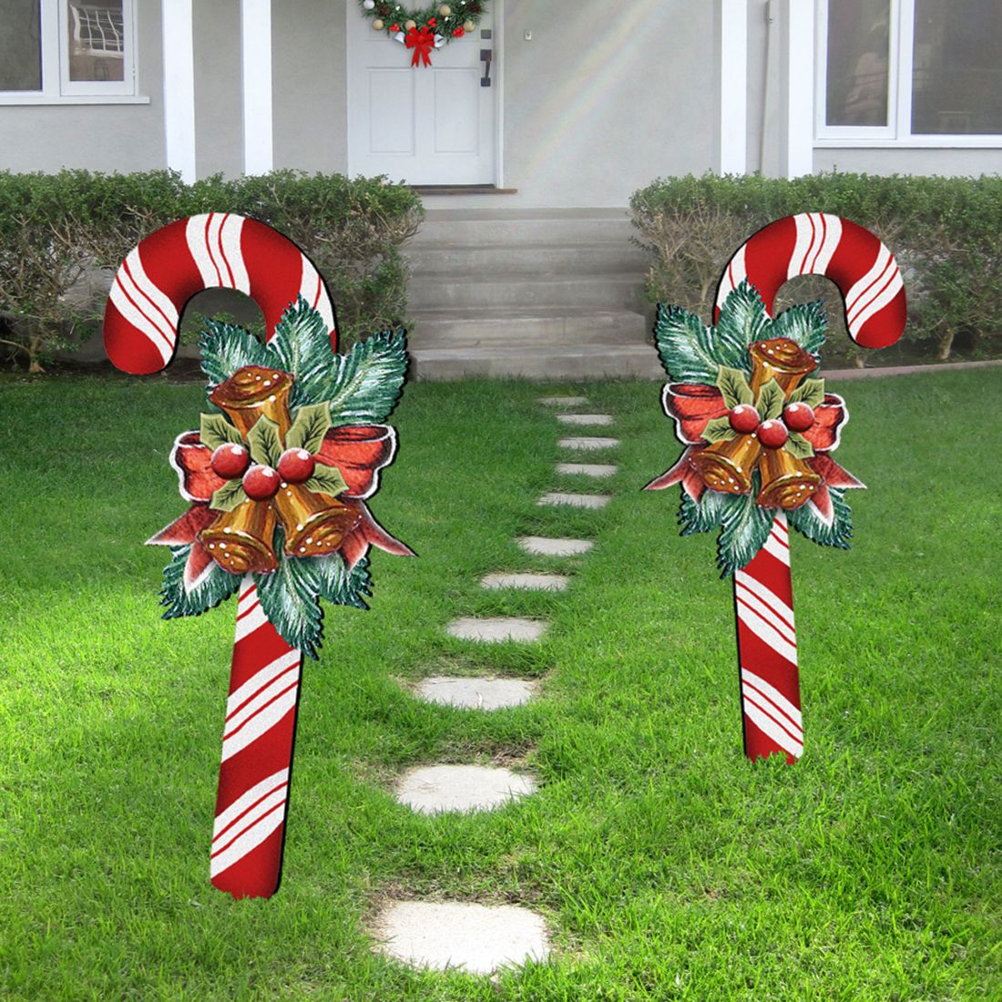 Christmas candy cane yard stake with bells, berries, and greenery