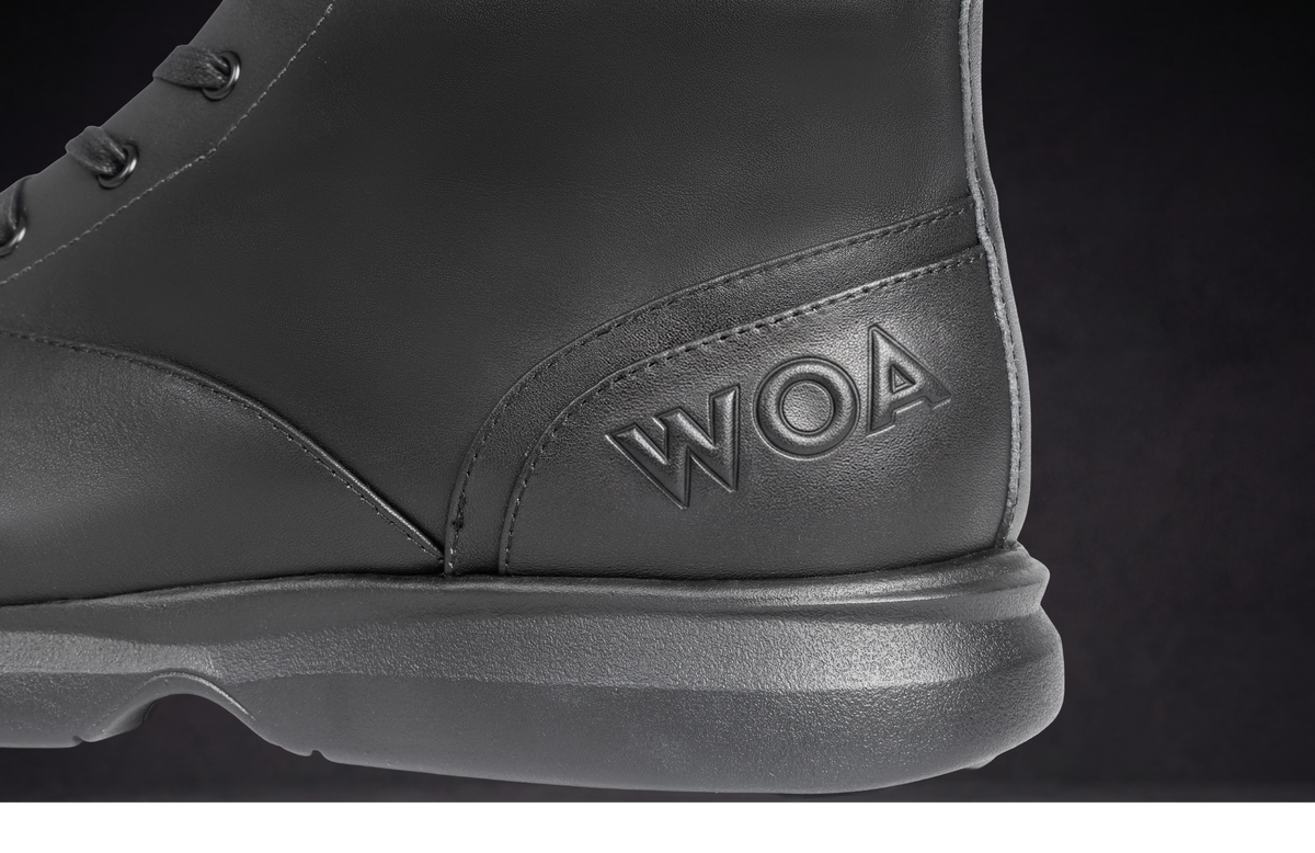 WOA lace-up boot close-up with embossed WOA logo on side and thick sole