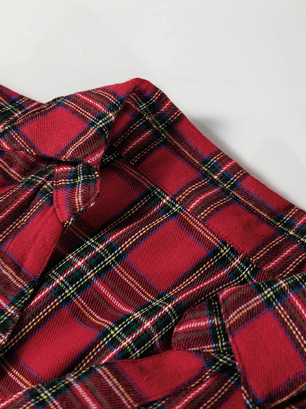 Burgundy plaid mini dress with ruffle hem and long sleeves, half-button front
