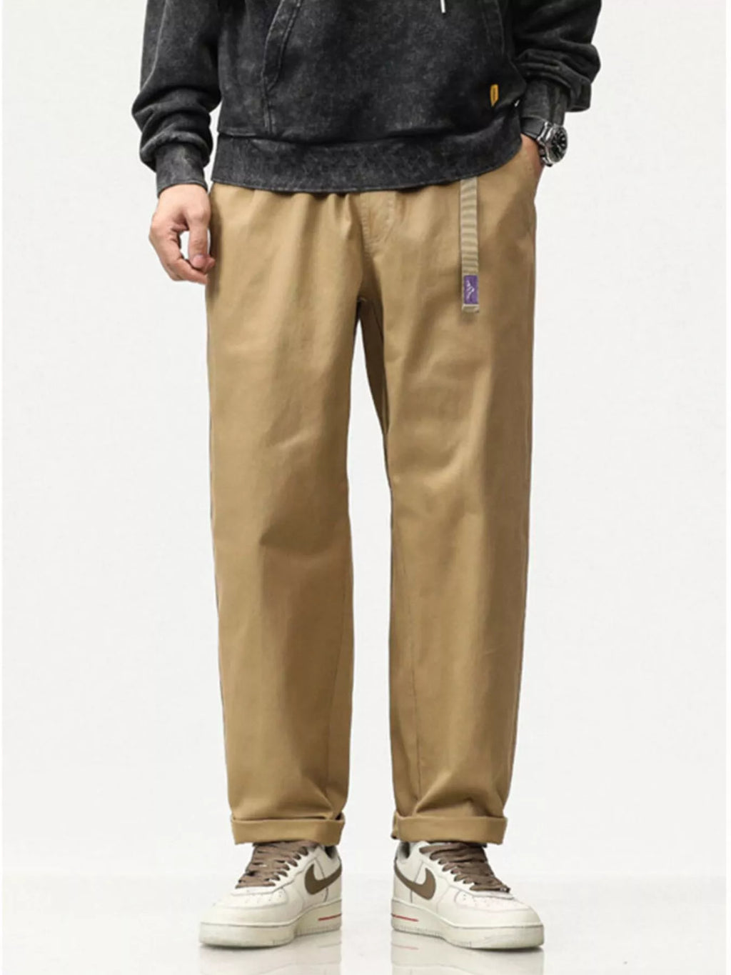 Khaki loose-fit pants with cuffed hems, side pockets, and small label patch