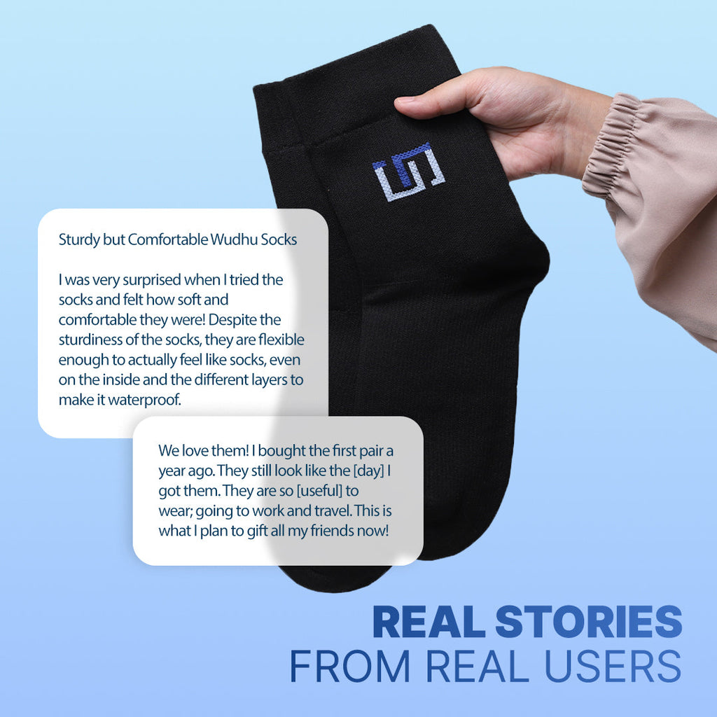 Black crew socks with blue logo patch held in two hands
