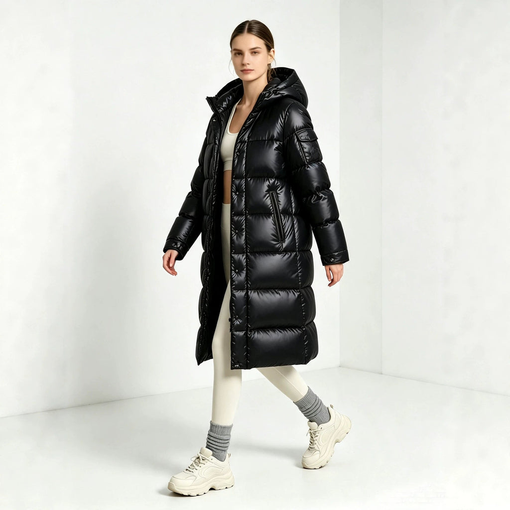 Black long padded hooded coat with front zipper and quilted panels, over-the-knee length