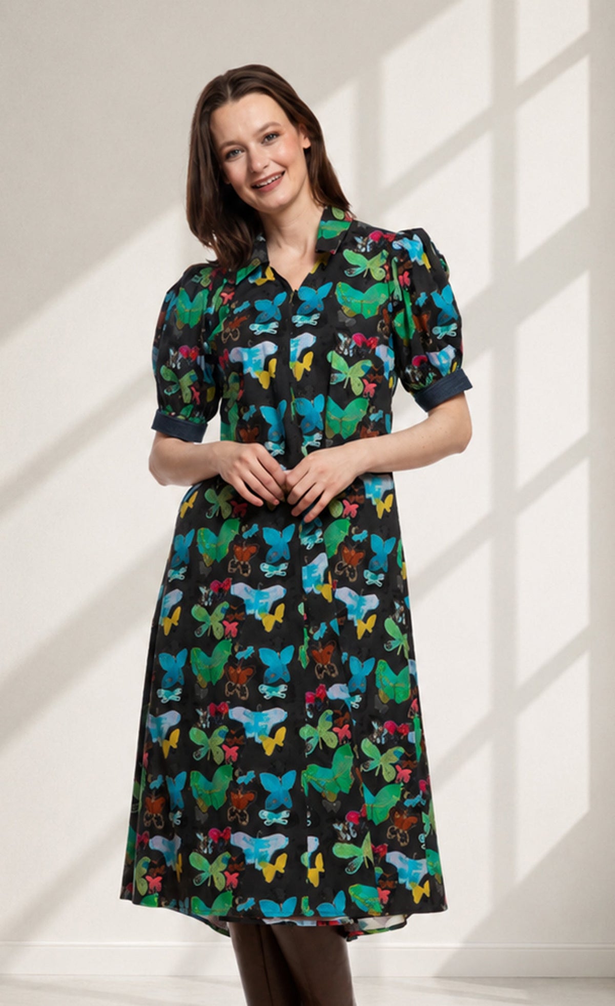 Black collared short-sleeve dress with colorful butterfly print and gathered waist