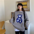 Women’s gray knit sweater with long sleeves and blue abstract heart graphic
