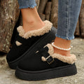 Black platform slippers with fuzzy trim and buckle strap detail
