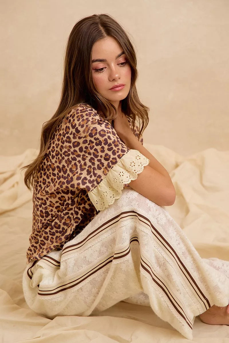 Leopard print ruffled top with eyelet lace shoulder trim and striped elastic-waist shorts
