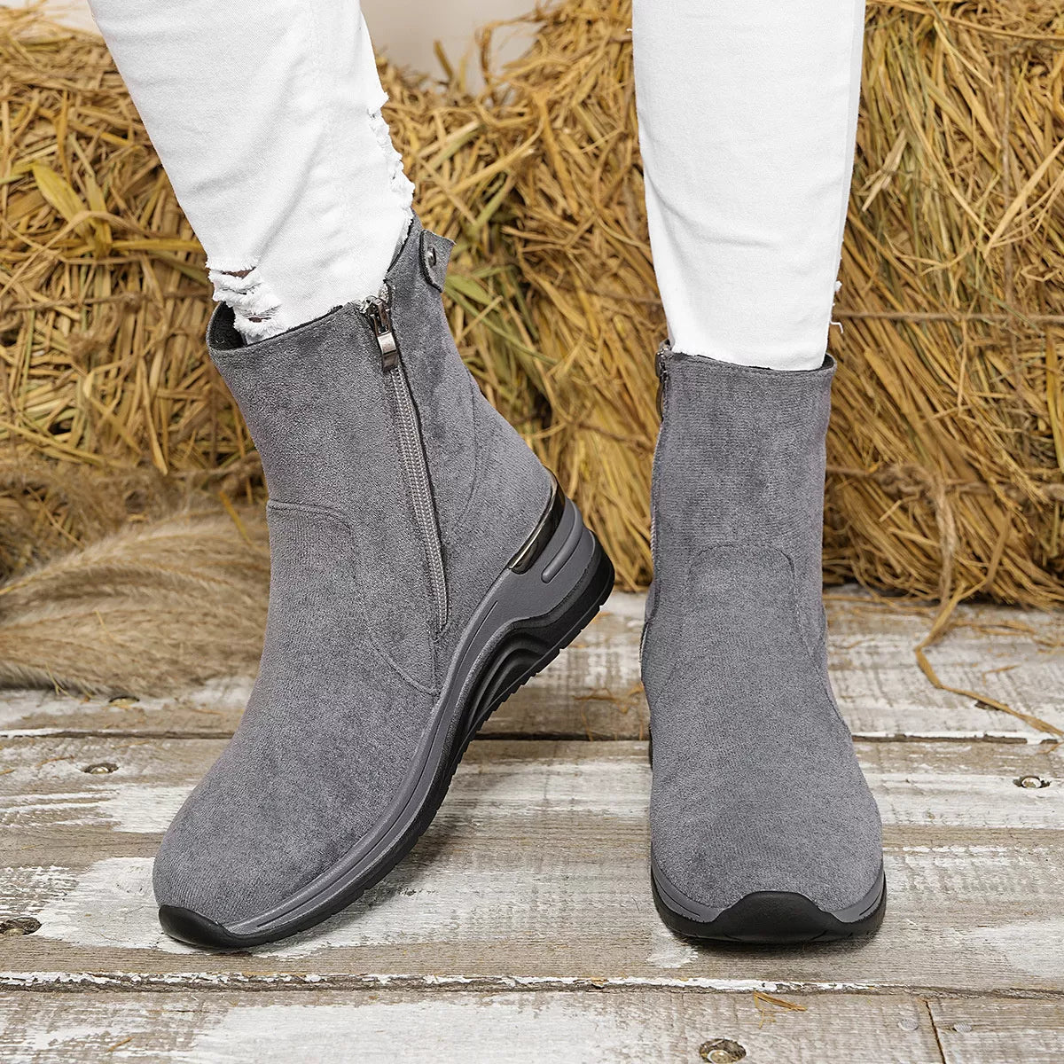 Gray suede ankle boots with wedge heel, side zipper and dark rubber outsole