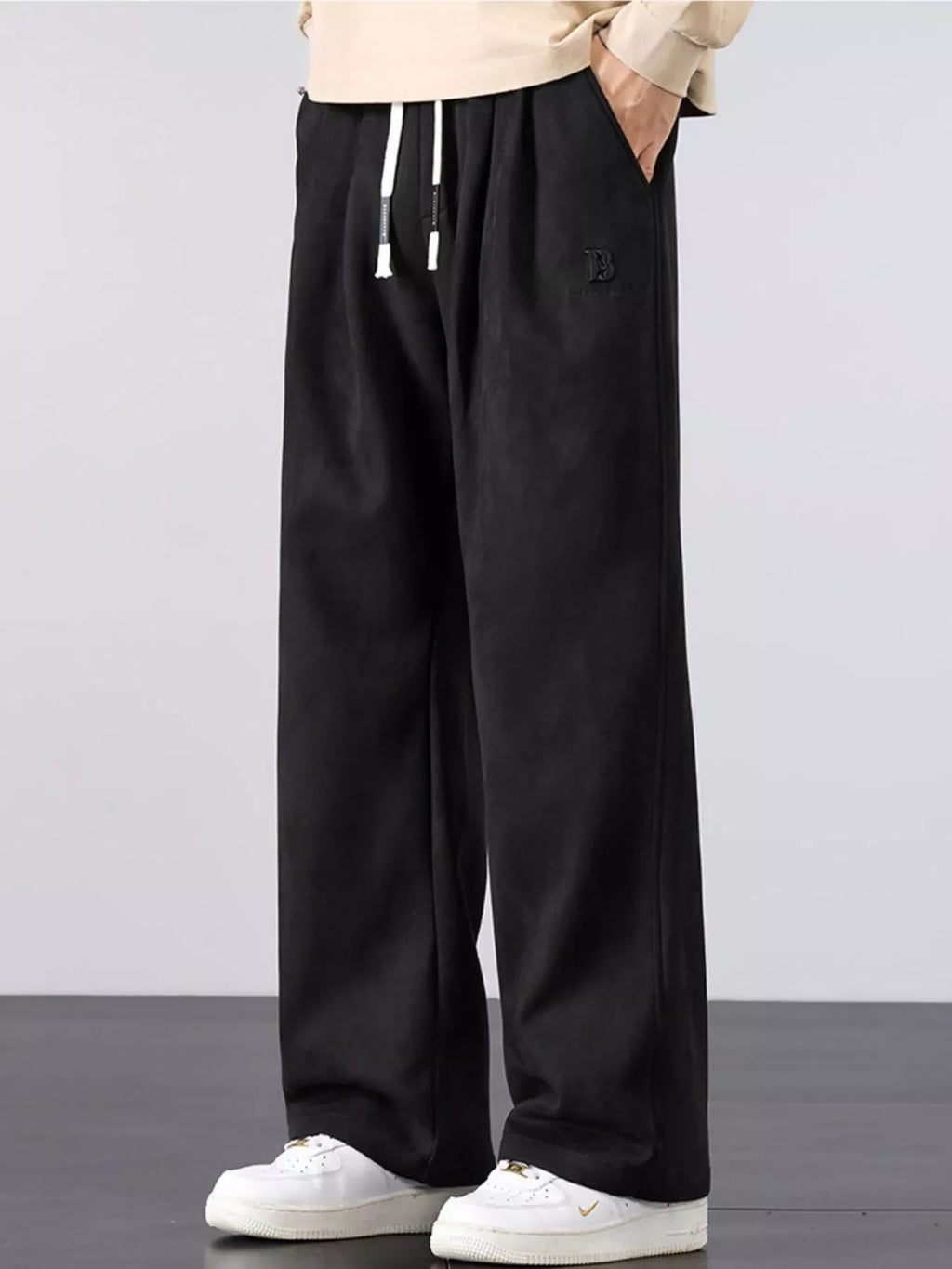 Men's black wide-leg drawstring pants with elastic waist and side pockets